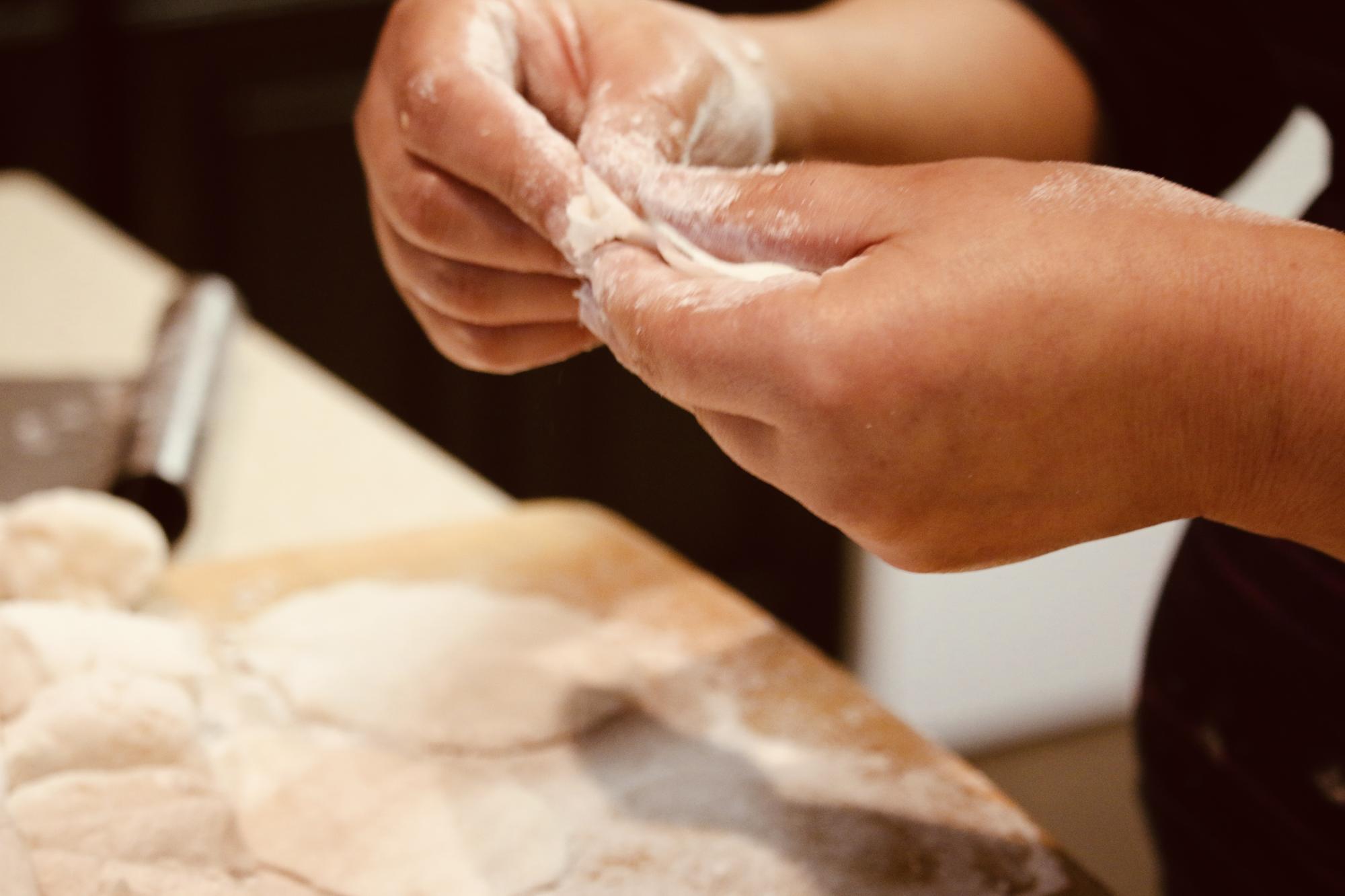 Close-up of hands kneading dough